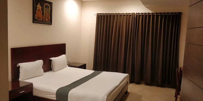 Deluxe Room bedroom and interior layout at Padmavathy Nilayam